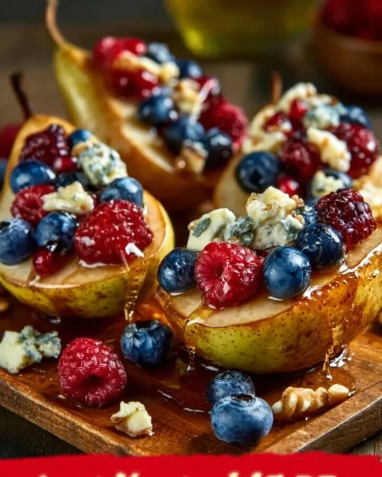 Baked pears topped with berries, honey, walnuts, and blue cheese